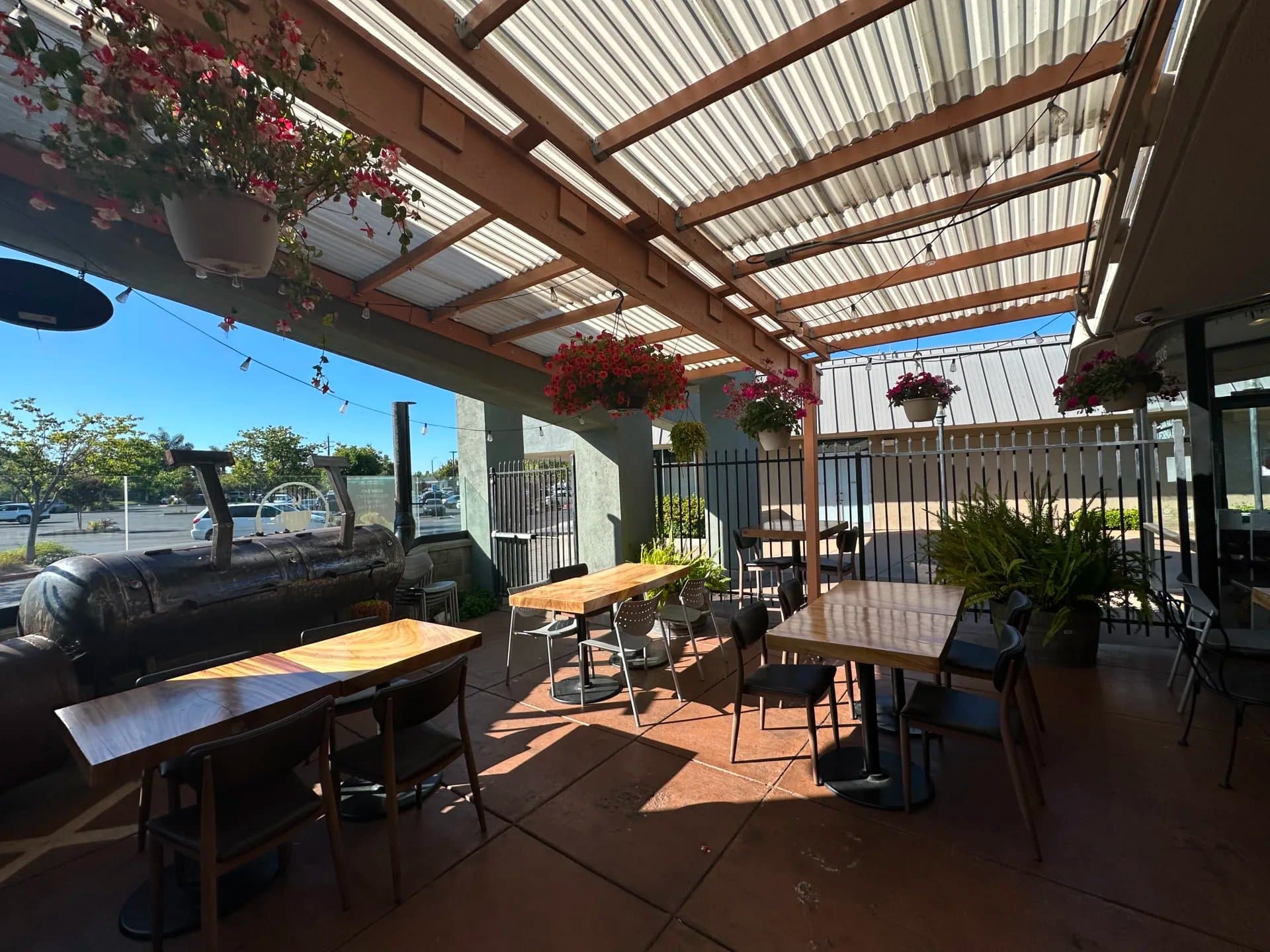 Covered outdoor patio with hanging flowers at iJava Cafe Willow Glen